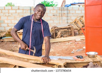 Local African Carpenter At Work Smiling