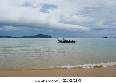 Local Asian Fisherman Boat On The Sea With Low Floating Clouds.