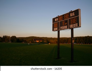 A local baseball scoreboard in some pretty light.