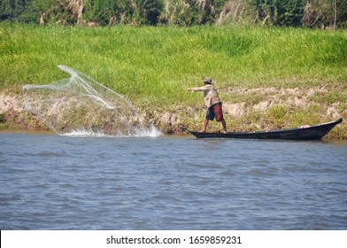 A Local Tapajós Basin Fisherman Casts A Net In The Tapajos River Of Santarem, Para, Brazil.