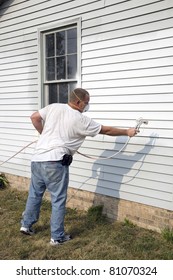 Local Contractor Painting Outside Of House, Business Is Booming In Summer Months