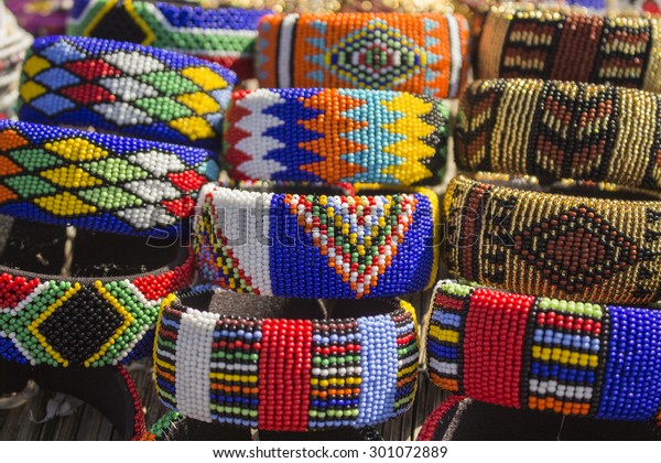 Local craft market in South\
Africa. Unique handmade colorful beads  bracelets, bangles.\
Craftsmanship. African fashion. Traditional ornament,\
accessories.
