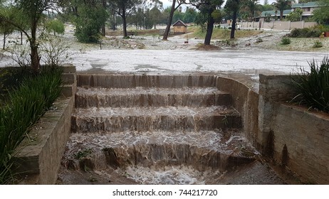 Local dam catchment for rain water in suburban area. Damage to plants and homes in Krugersdorp, South Africa after heavy storm with massive hail and small tornado.  - Shutterstock ID 744217720