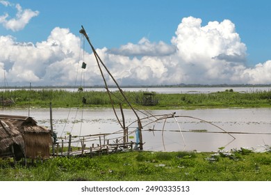 Local fishermen's riverside huts and nets for catching fish, at Nong Han, Udon Thani Province, Thailand. - Powered by Shutterstock