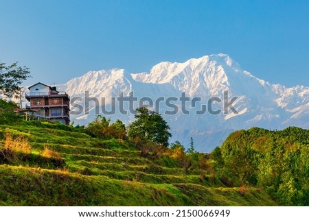 Local house and Annapurna massif view from Sarangkot hill viewpoint in Himalayas mountain range in Pokhara, Nepal