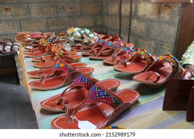 A Local Made Sandals Displayed On A Table In Local Market