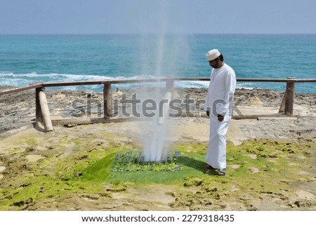 Local man watching Blow Hole in Mughsayl, Dhofar Region, Oman