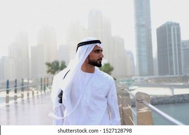 Local Middle Eastern Arab man looking on his side wearing Kandura traditional UAE menswear