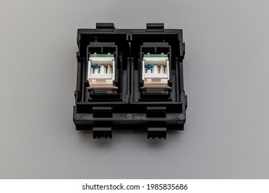 Local Network Socket Against Gray Background. Power Outlet For Accessing The Internet. Home Electrician For Repair. Data Transfer Concept. Close-up. Full Focus. Copy Space