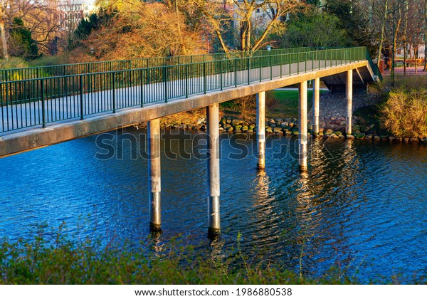 Local park with\
pedestrian bridge in Malmo Sweden . Footbridge over the river .\
Parkbron park bridge in Malmo\
