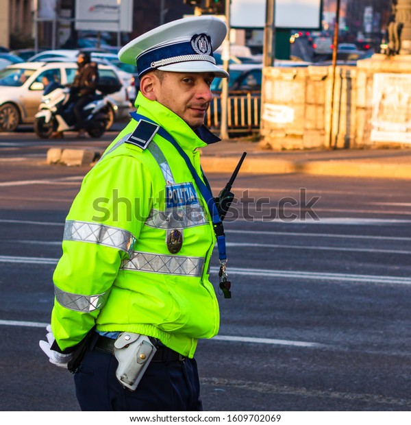 Local police man, Romanian police man, traffic\
police man (Politia Rutiera) directing traffic in Bucharest,\
Romania, 2020