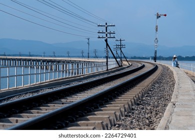Local railway track across the river or Pa Sak Dam in Lopburi, Thailand, train over the river in Loburi