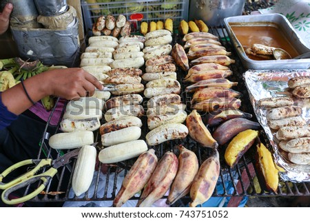 Local seller make Roasted Pisang Awak banana and Musa silver bluggoe at Saphan Khwai, Bangkok, Thailand