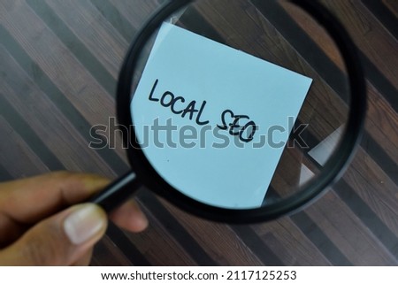 Local SEO write on sticky notes isolated on Wooden Table.