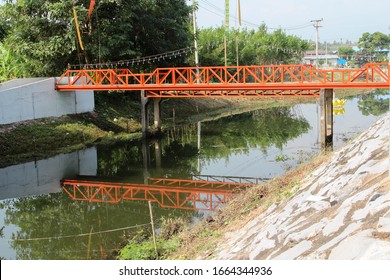 Local Small Steel Bridge Over The Small River In The Village.