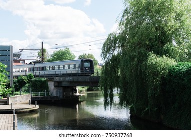 Local Train Crosses A Canal On A Bridge In Aarhus.