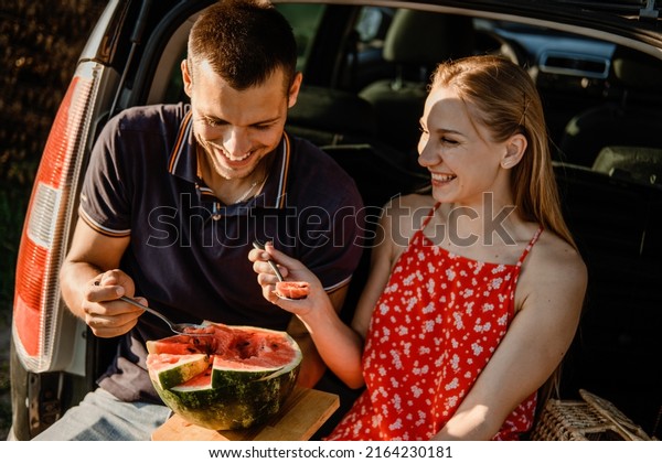 Local travel, Romantic
Picnic Date Ideas. couple in love on summer picnic with watermelon
in car trunk