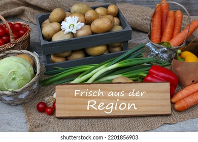 Local vegetables with the text frisch aus der Region on a wooden sign, frisch aus der Region means fresh from the region. - Shutterstock ID 2201856903