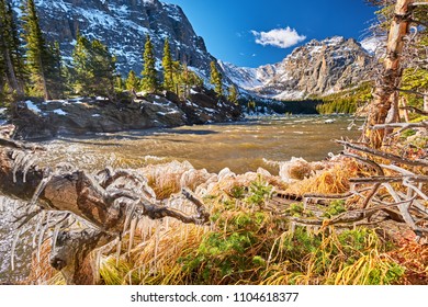 The Loch Lake with rocks and mountains in snow around at autumn. Icicles on trees created by wind and water. Rocky Mountain National Park in Colorado, USA.  - Powered by Shutterstock