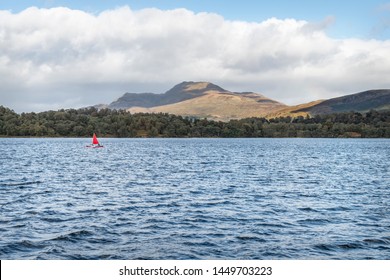 Loch Lomand, Scotland - Sept 30 2018; Sail Boat With Red Sail On Loch Lomand