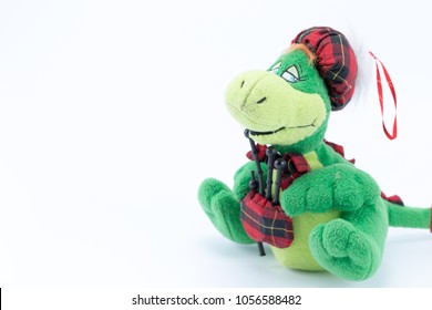 Loch Ness Monster Icon Plush Stuffed Toy With Bagpipe And Checked Tartan Hat Isolated On White Background. Scotland Country Symbol