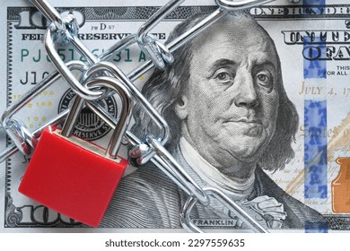 Lock and chain on cash, money restrictions, frozen assets, business finances concept - Shutterstock ID 2297559635