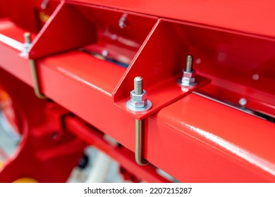 Lock nut. Using a second nut to prevent unscrewing. Lock nut. A fragment of a red agricultural machine