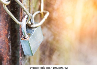 lock on a chain hangs on a gate - Shutterstock ID 1083303752