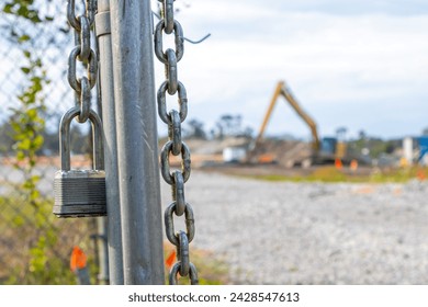 Lock on the open gate of a construction site
