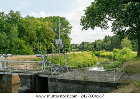 Lock 'Sas 3' forming a bridge over the Little Nete in Grobbendonk, offering picturesque views of the waterway