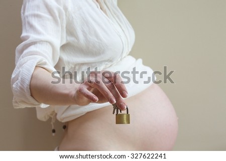 A lock with two keys in the hand of a pregnant woman Stock photo © 