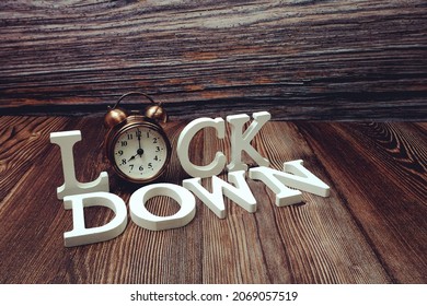 Lockdown Alphabet Letters With Alarm Clock On Wooden Background