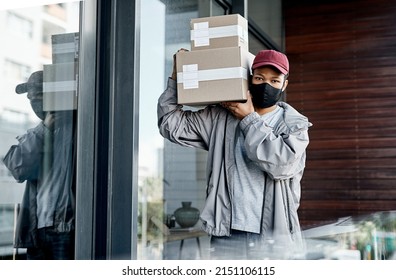 If Its Lockdown, Ill Leave It At Your Door. Shot Of A Masked Young Man Delivering A Package To A Place Of Residence.