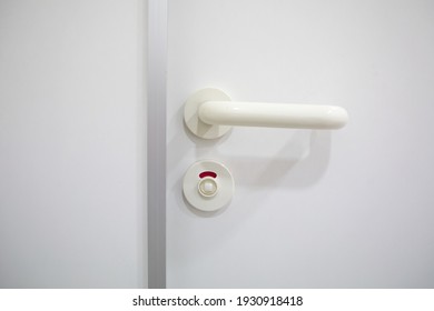 Locked Bathroom Door With Red Sign Shows Someone Is Inside The Cabin And Need Some Privacy To Relieve, Thats Why The Person Turned To Knob To Lock The Entrance Of The Wc