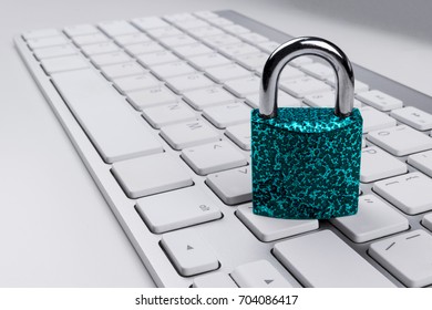 Locked computer safe from virus or malware attack. Laptop computer being protected from online cyber crime and hacking. Computer security concept with a padlock on a keyboard. protection various risks