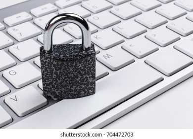 Locked computer safe from virus or malware attack. Laptop computer being protected from online cyber crime and hacking. Computer security concept with a padlock on a keyboard. protection various risks