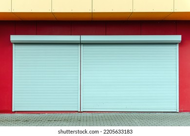 Locked door on a business that has gone bankrupt.shop exterior with closed shutters. Small business problems.Shop entrance is closed by automatic gates.