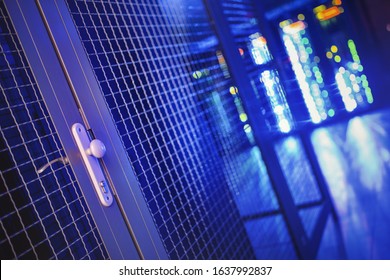 Locked door of a secure datacenter section with other servers in the background.