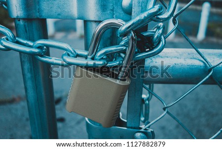 Locked Gate/Boarder Tethered by metal chain and padlock. Toned photo. Closed borders immigration concept. 