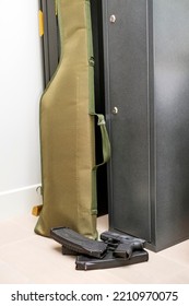 A Locked  Gun Safe, Ammunition And Case In A Gun Room, A Vertical Shot