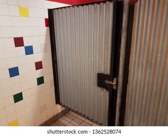 Locked Sheet Metal Bathroom Or Restroom Stall Door And Colorful Tiles