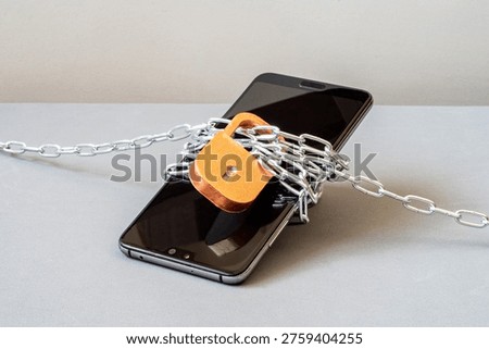 A locked smartphone, wrapped in chains, a lock. Forgotten password, no service. Blocked for non-payment. Data protection, blocking of online platforms. Broken phone. Stopping WiFi radiation, limiting calls