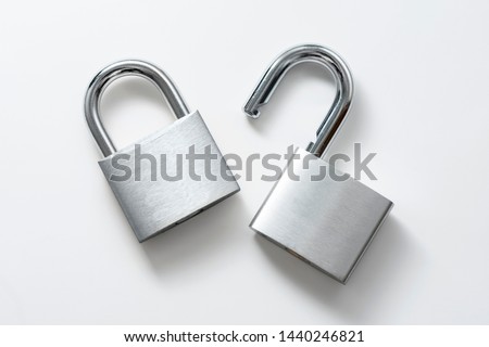Locked and unlocked silver padlock on the white background.