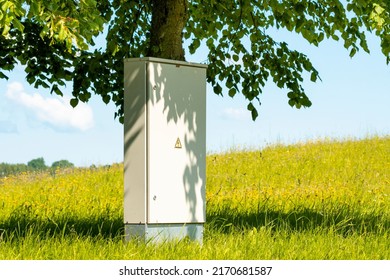 Locker of electric system under tree. Outdoor electric high voltage distribution cabinet in a park. - Shutterstock ID 2170681587