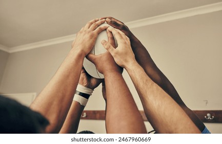 Locker room, hands together and rugby team huddle with with ball, motivation and teamwork before game. Training, coaching and group of motivated sports players with commitment, dedication and support - Powered by Shutterstock