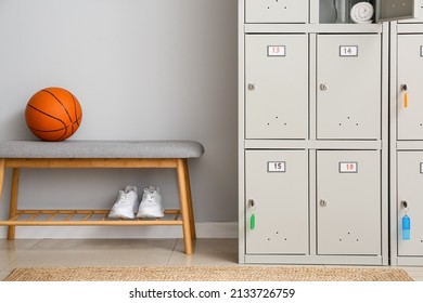 Locker With Sport Equipment And Bench In Change-room