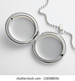 Locket with chain on white table