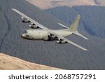 Lockheed C-130 Hercules military transport plane flying low level in the united kingdom