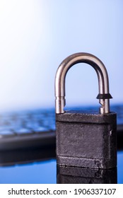 Locking the computer keyboard. The lock and keypad are tinted blue. Information security concept.