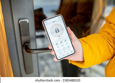 Locking Smartlock On The Entrance Door Using A Smart Phone Remotely. Concept Of Using Smart Electronic Locks With Keyless Access